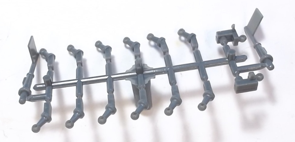 STANCHION / HANDRAIL / PLASTIC / UNPAINTED / SLANTED / 3.1mm x 2.4mm MOUNTING STUD / 6.9mm L (FROM BOILER) / SPRUE W/12 PLUS 2 PILOT FLAGS /RAILKING ONE GAUGE BIG BOY